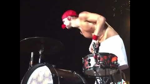 Josh Dun puts a flower in his mouth