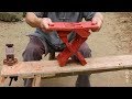 Elderly artisan makes bench with single piece of wood