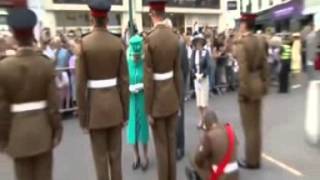 Soldier sits and honours the Queen