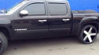 2009 GMC Sierra sitting on 26" DUB Baller Chrome wheels and Lexani 305/30-26 tires.