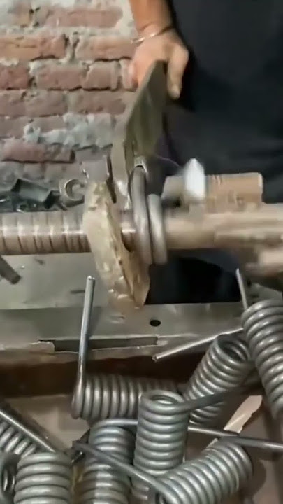 bending an iron rod to be made into a spring using simple tools