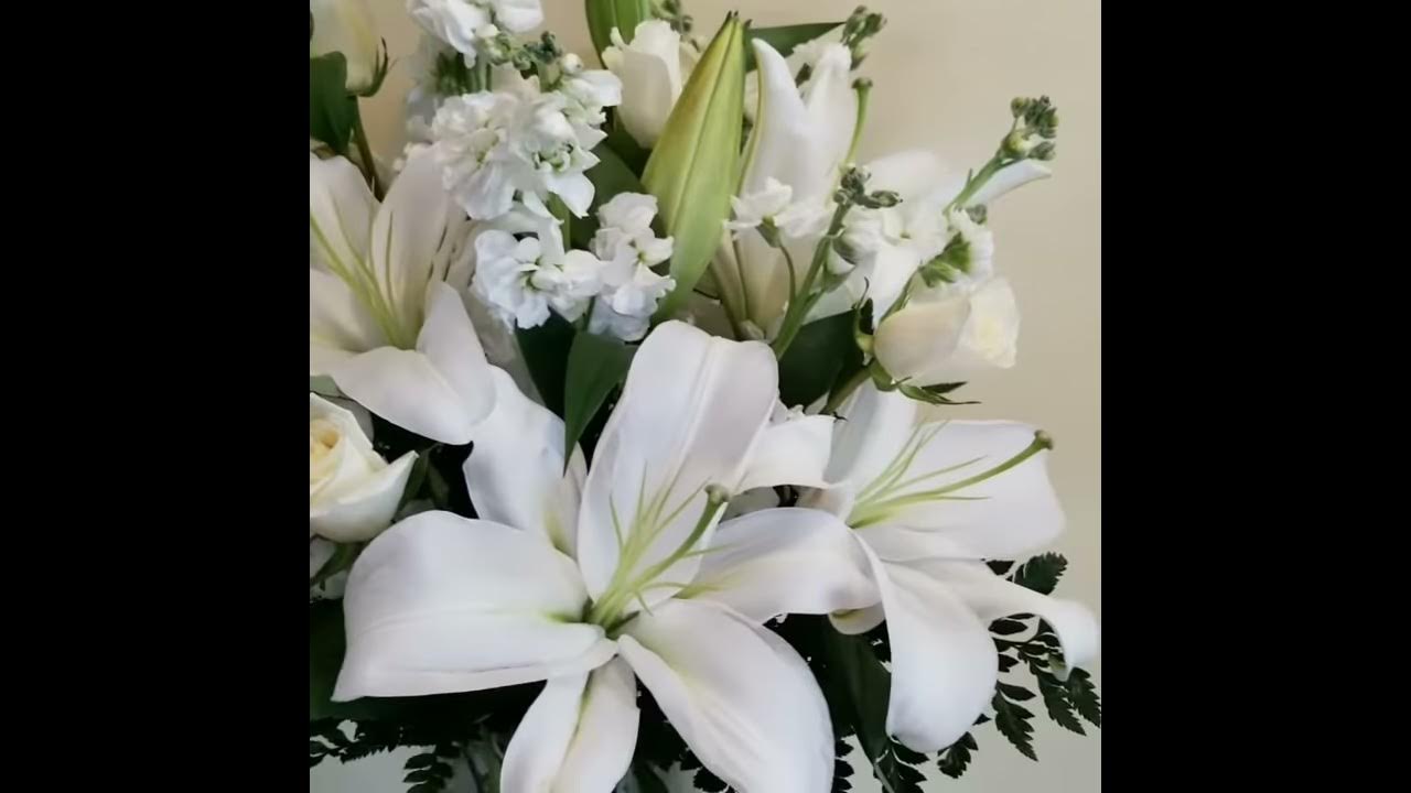 Funeral / Sympathy arrangement with all white flowers