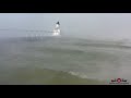 A relaxing flight in 30 windchill  fog over lake michigan lighthouse 4k drone footage