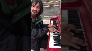 guy playing piano outside