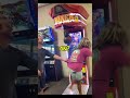 Woman does something strange in an arcade