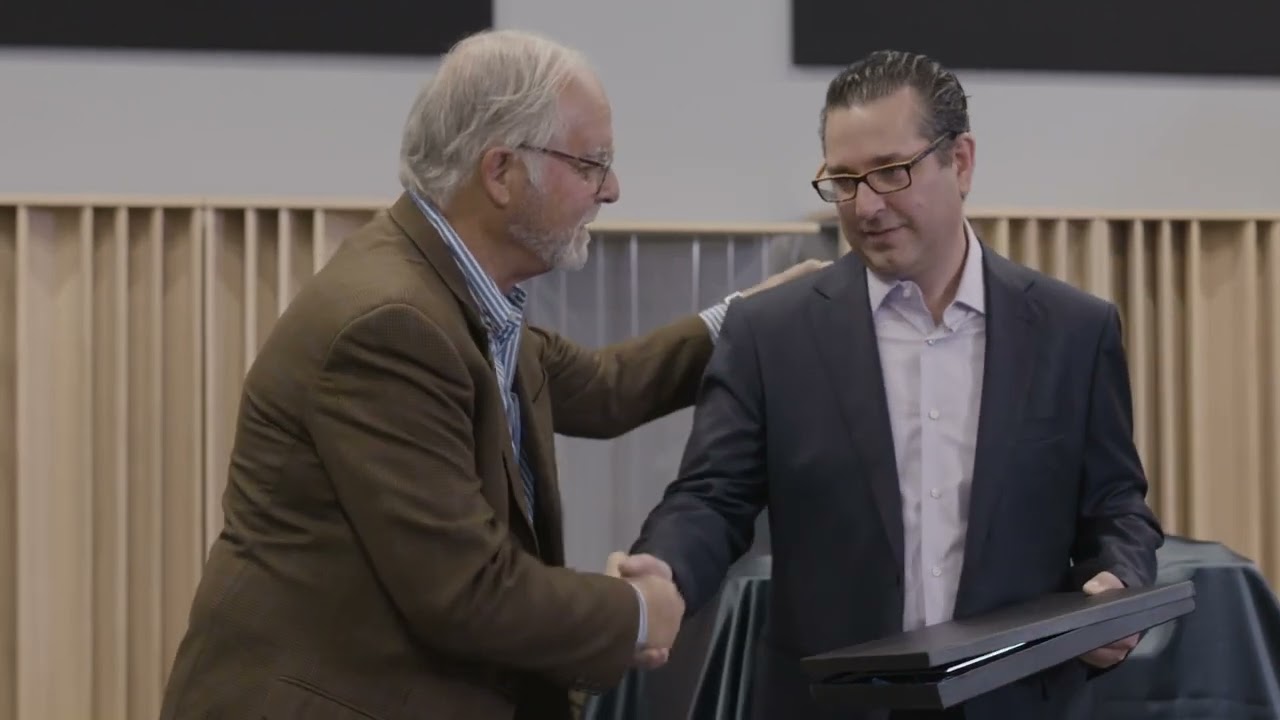 Peter McGrath of Wilson Audio presents Maier Shadi with the Wilson Dealer of the Year award for 2018