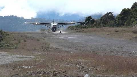 External View Susi Air Cessna Grand Caravan C208B Landing in Bilogai, Papua, Indonesia