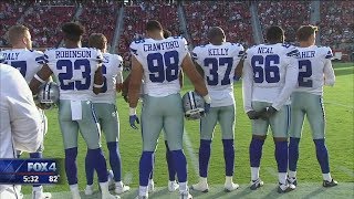 Cowboys stand during anthem; other players protest