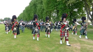 Drum Majors lead the final march of the massed Pipes and Drums at 2023 Oldmeldrum Highland Games