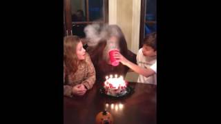 Practical joke. Woman blows flour onto her face from birt...