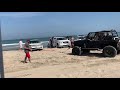 Old lady got her fancy land rover stuck in sand at beach