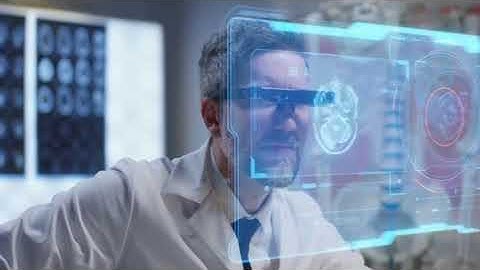 medium close up of a vr headset wearing doctor using an interactive holographic display for research