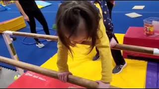 Toddler gymnastics bear crawl on paralel bar