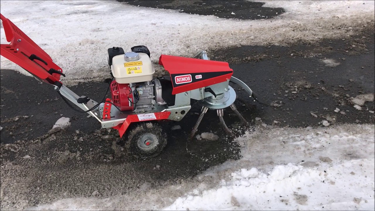 Nimos Mosquito clearing hard packed ice and snow from tarmac