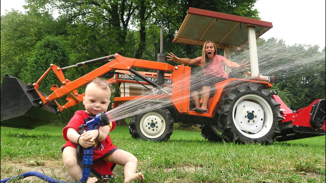 Playing in the mud and watering hay with tractors Tractors for kids