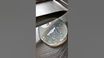 cerulean obsidian shaped like a teapot, sliced into spiraling luminous ribbons