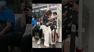 Romantic Gestures on Public Transportation: A Couple's Sweet Interaction