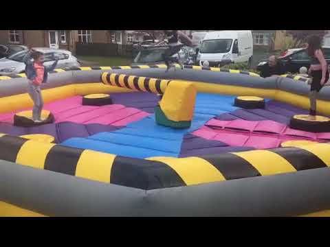 glasgow airport Kids having the best time on an inflatable Wipe out game