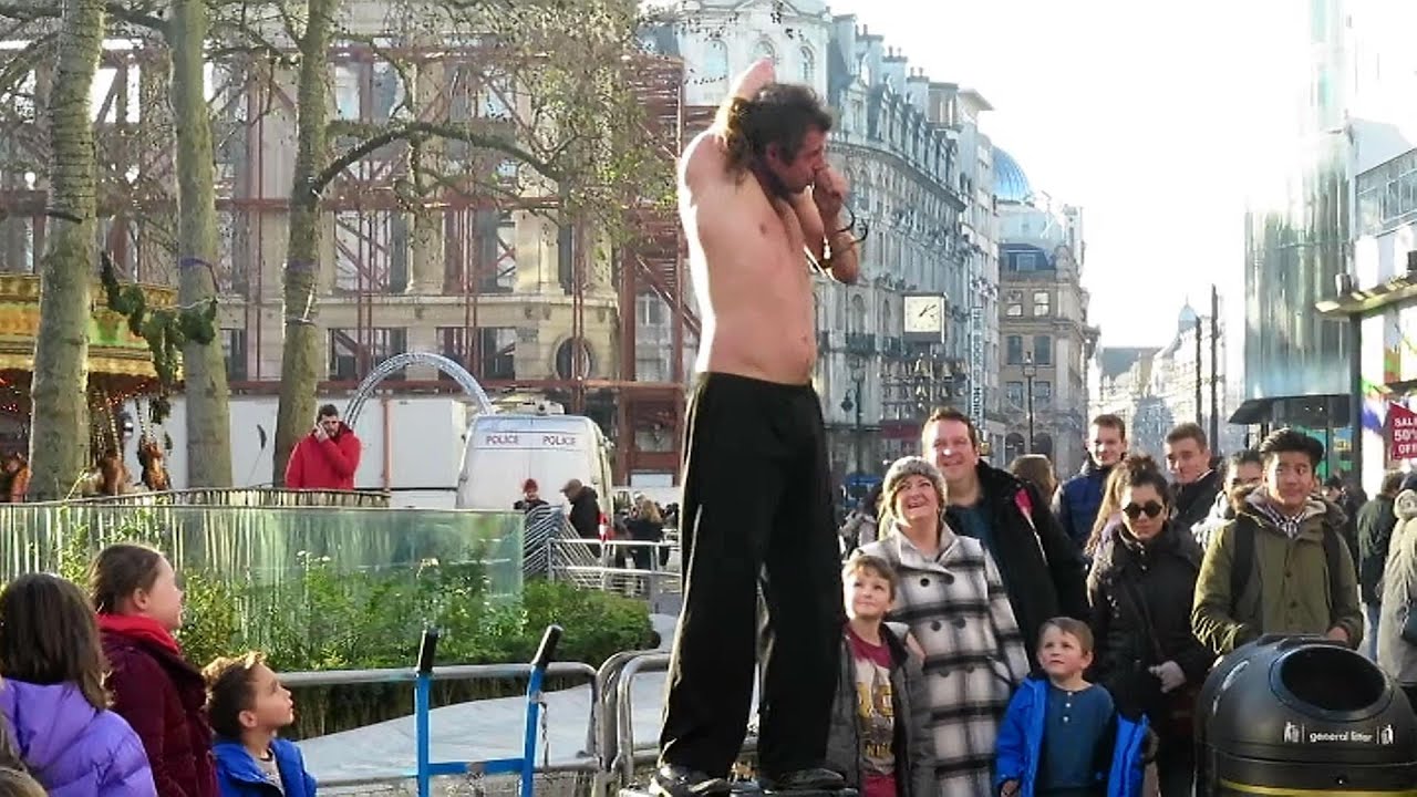 Contortionist dislocates his shoulder and squeezes through a tennis ...