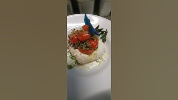 seared halibut with shallots grape tomatoes over asparagus in a garlic lemon cream sauce