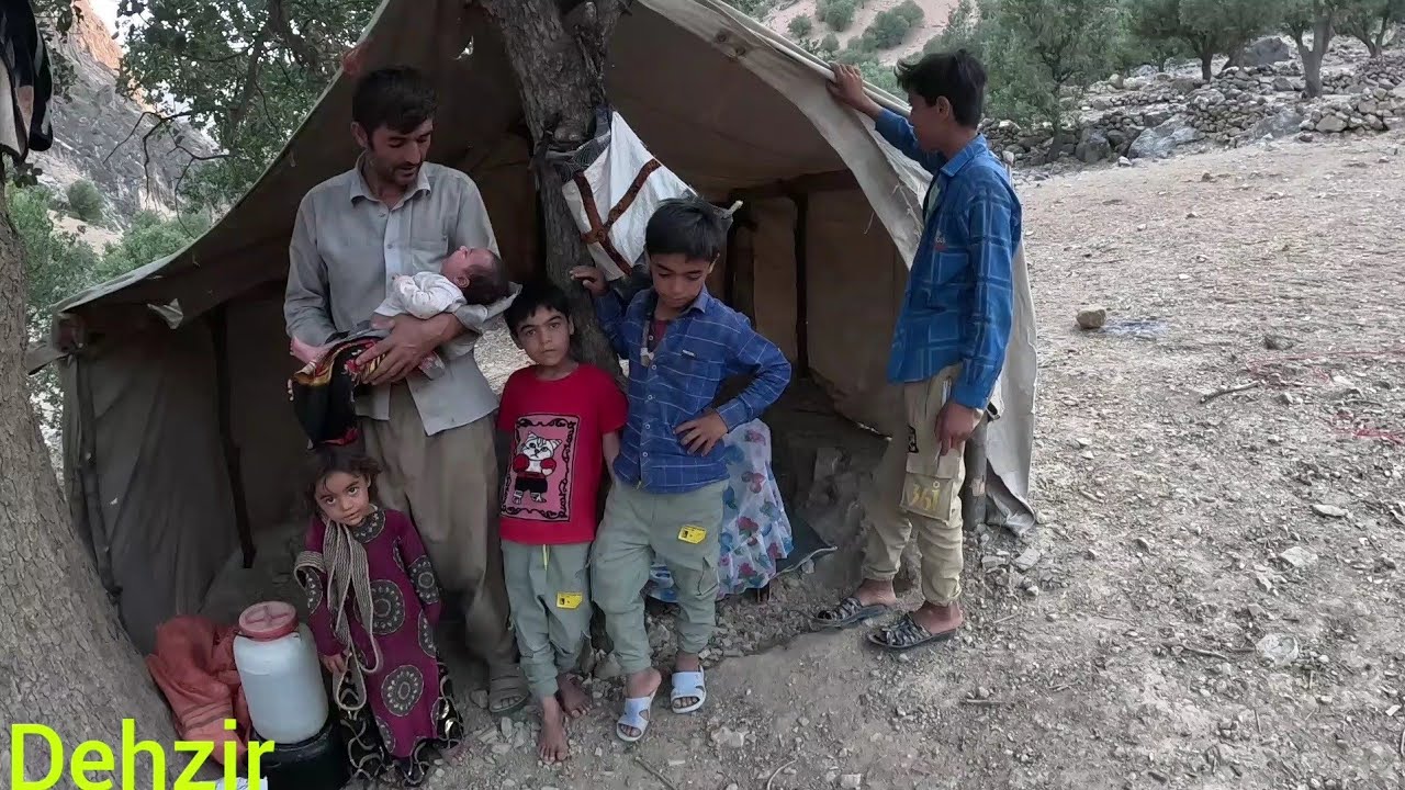 Setting up a tent by a nomadic man with children for Rafa at night ...