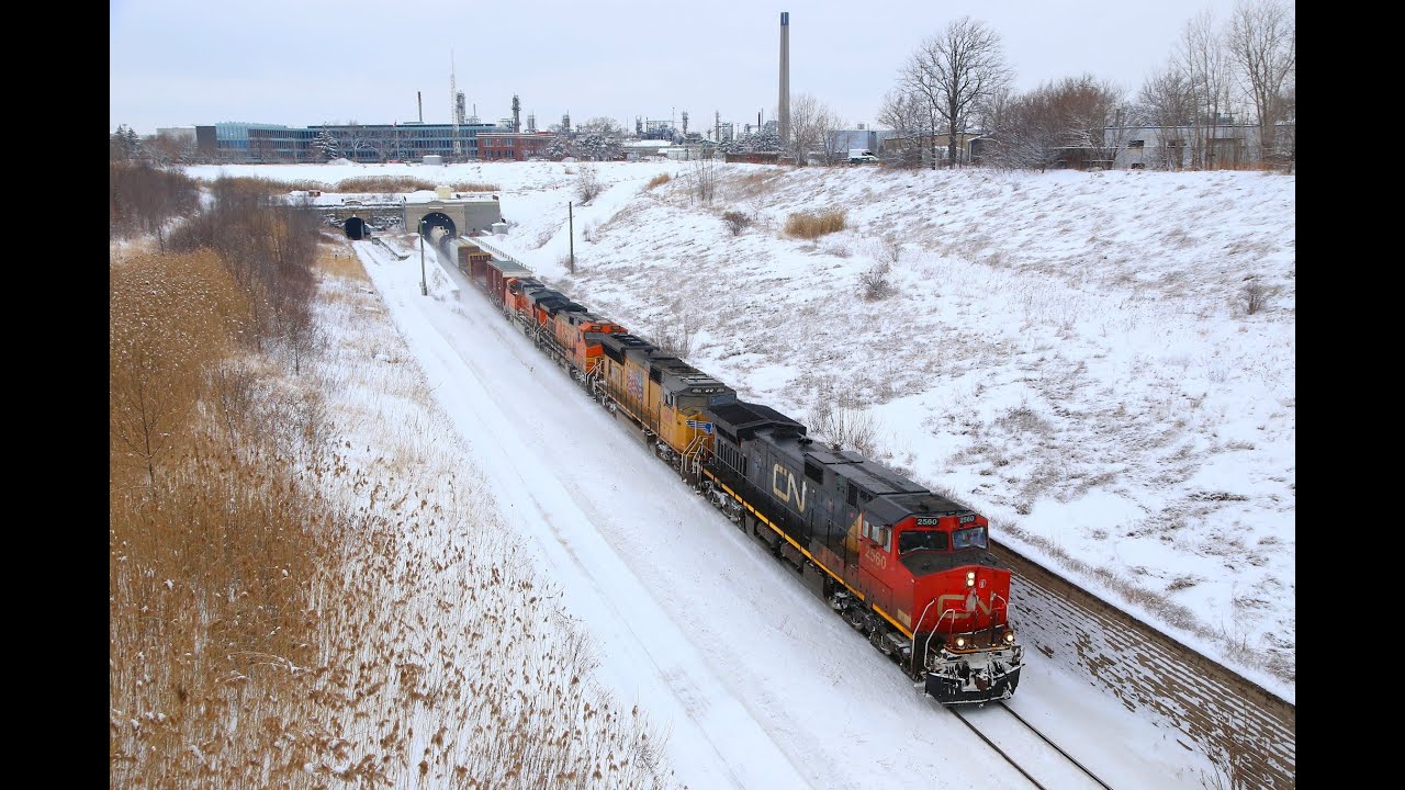 CN2560 + UP4818 + BNSF4002 + BNSF5803 emerge from the St Clair Tunnel in Sarnia    02/02/14