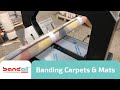 Banding Rolls of Carpets and Mats