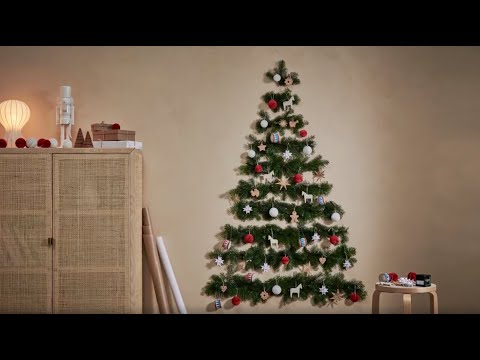 Vidéo: Faire un bel arbre de Noël sur le mur à partir de guirlandes et de guirlandes