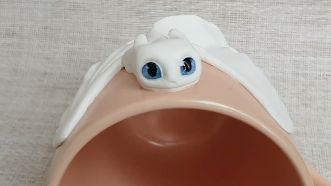 Light Fury from How to Train Your Dragon. Snow White Day Fury dragon on a peach cup by AnneAlArt.