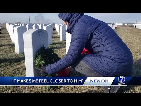 Families lay wreaths at Omaha National Cemetery in honor of fallen veterans