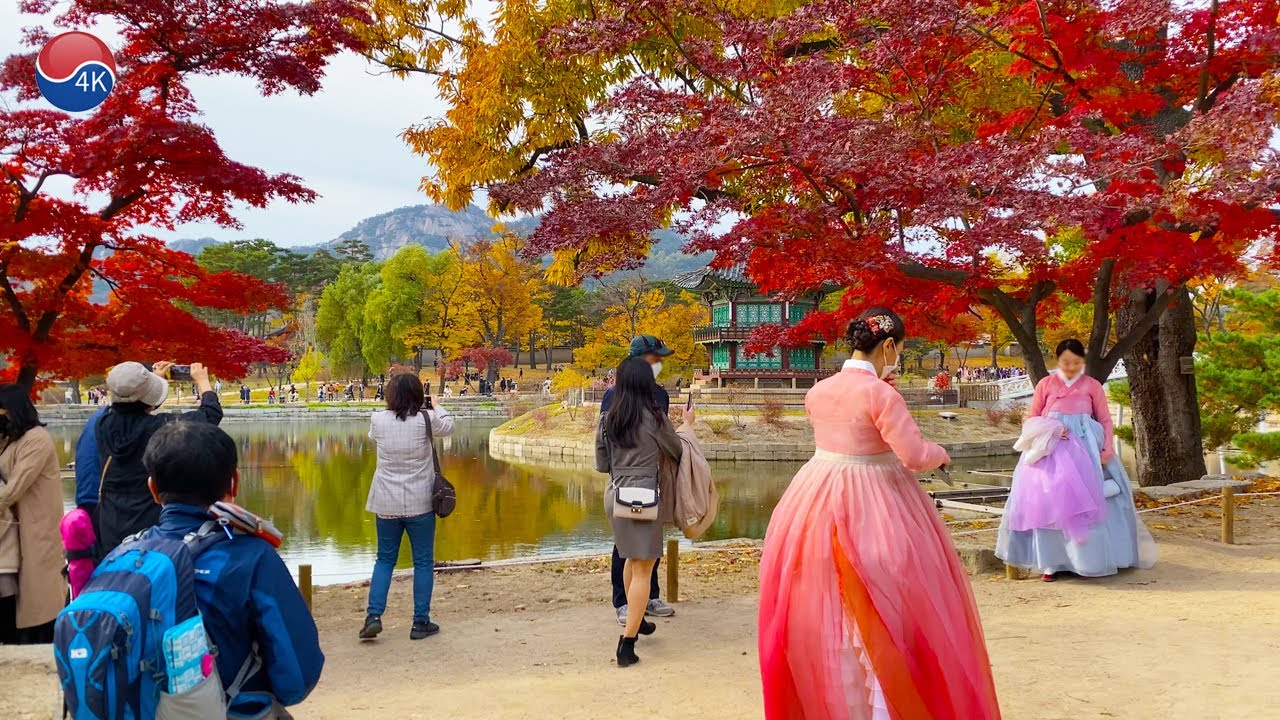 Seoul Gyeongbokgung Palace Beautiful Autumn Leaves. Seoul citizens wearing hanbok.