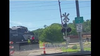 NS Train Conductor Flags Railroad Crossing Under Construction