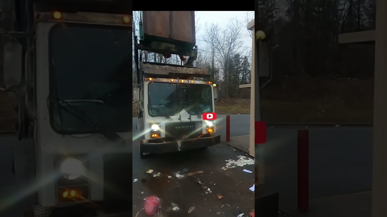 Garbage truck dumping dumpster