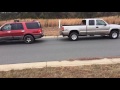 Ford Expedition pulling Chevy truck