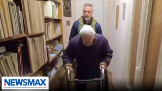 Newsmax reporter helps elderly woman in Ukraine | REPORT | 'John Bachman Now'