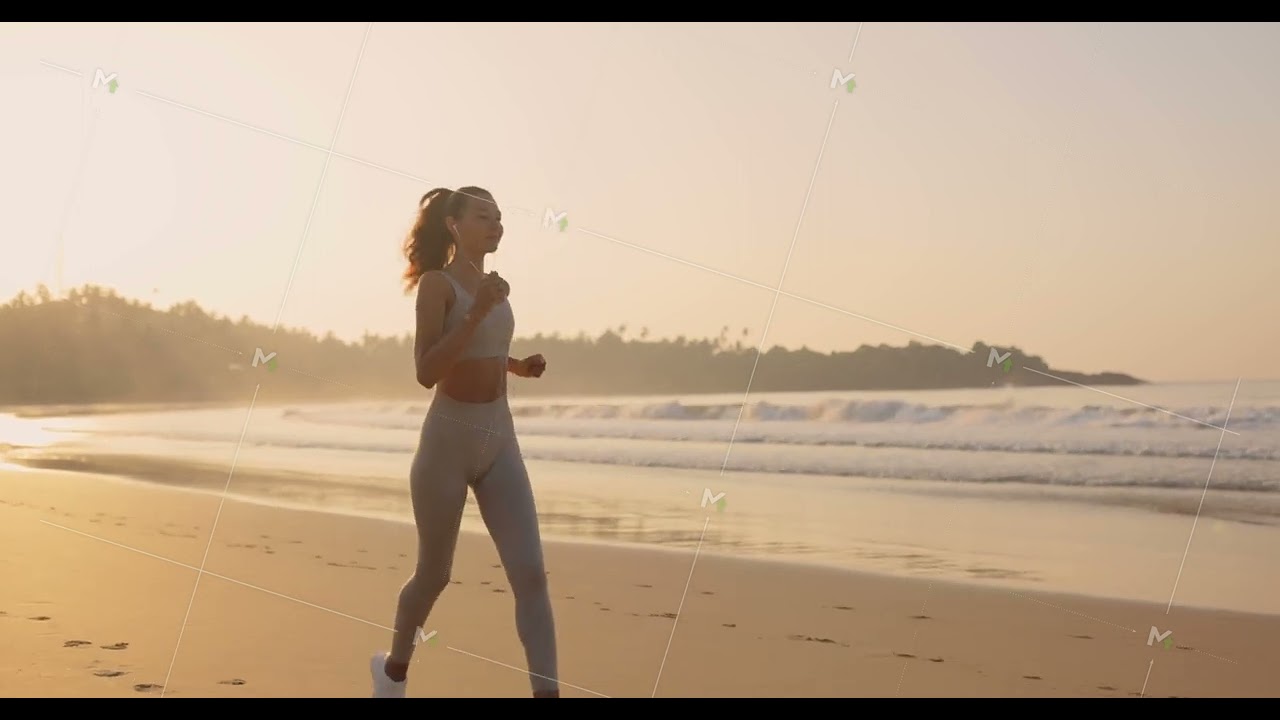 Female Runner Jogging During Outdoor Workout on the Beach in Slow Motion