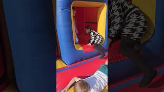 Happy Kids Playing In The Bouncy Castle .