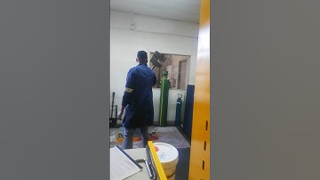 SWINGING AND DROPPING HEAVY MANUAL HAMMER IN PERFORMING CHARPY V-NOTCH IMPACT TEST IN LABORATORY
