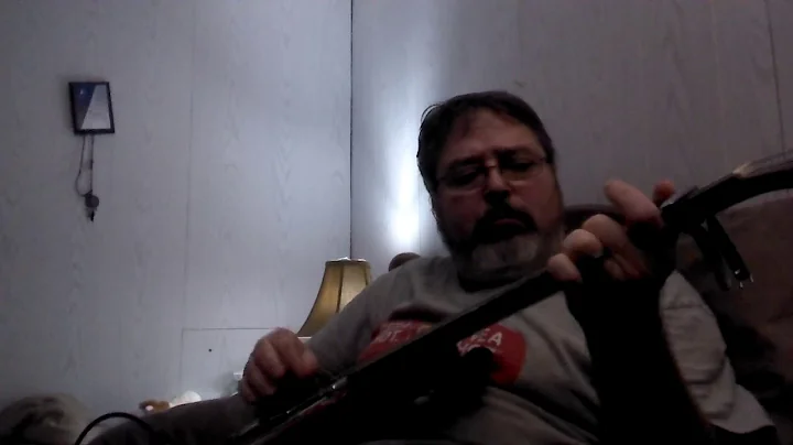 Roger Benson practicing electric guitar with a Bra...