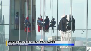 Superheroes scale Children's Hospital