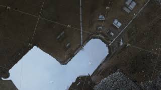 Reflective Puddle Capturing Urban Building And Sky