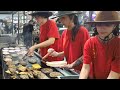 Street Food from the USA. Three Girls Master a Busy Grill of Meat