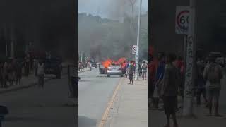 Car burning in the middle of the road