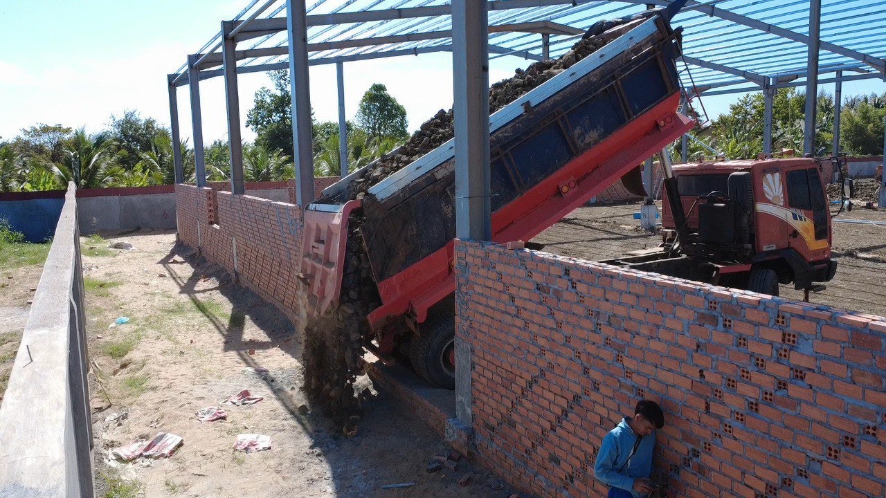 100% real skills of a 25-ton dump truck dumping rubble through a fence.