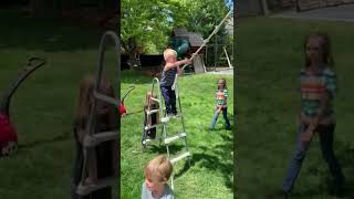 Boy on ladder rides rope swing and crashes into padded mat