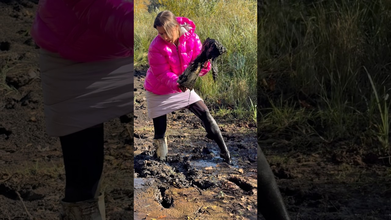 Hard stuck in deep mud messy beautiful Girl in Hunter wellies and shiny nylon rain jacket
