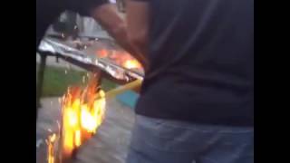 A blindfolded man hits a pinata into a fire