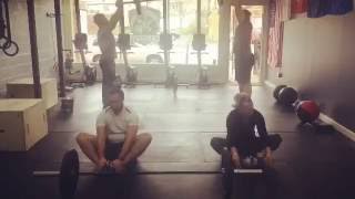 Synchronized Abmat Situps & Partner Log Thrusters @ CrossFit I/O