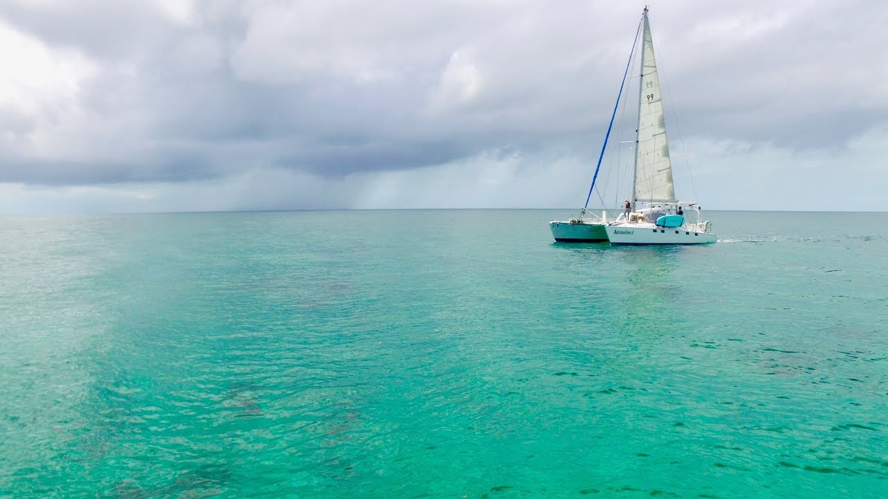 Catamaran motor sailing across a GLASSY Bahama Bank!