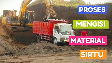 THE EXCAVATOR CATERPILLAR LOADING SAND STONE INTO THE DUMP TRUCK ISUZU ELF